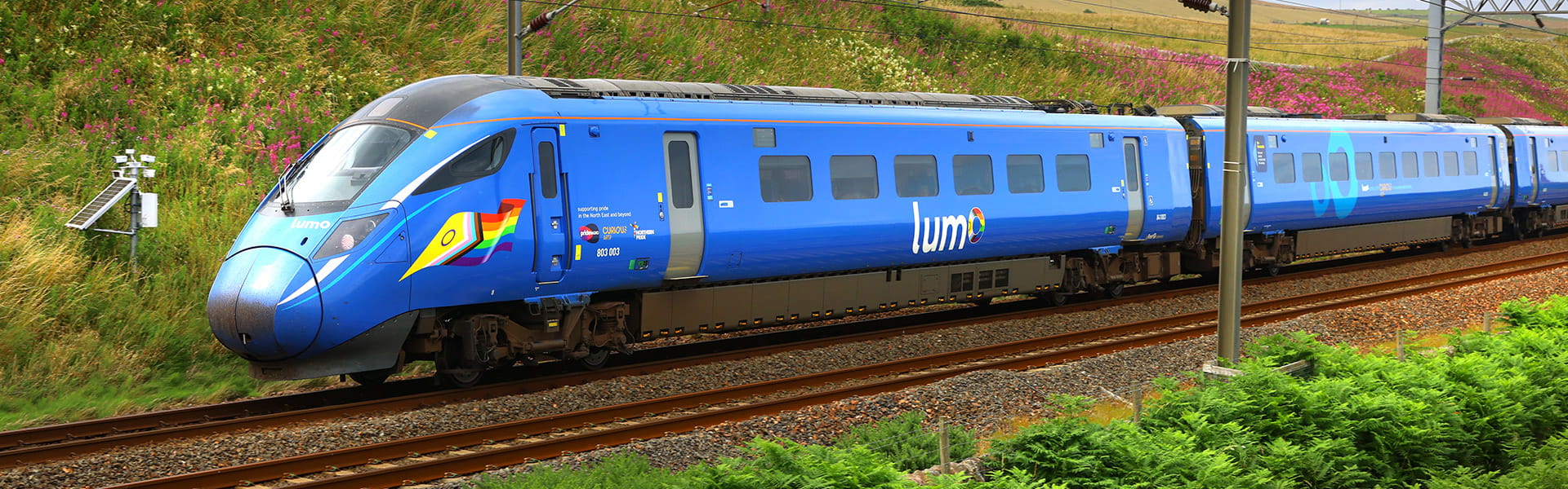 Lumo train passing through a field