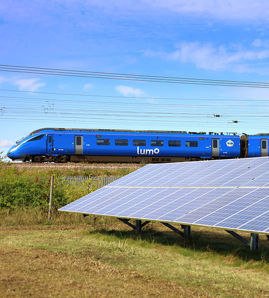 Lumo train next to solar panels