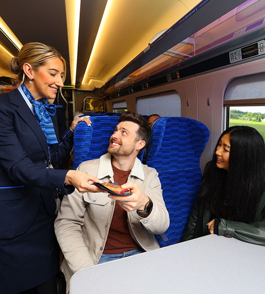 Lumo staff handing a snack to a passenger