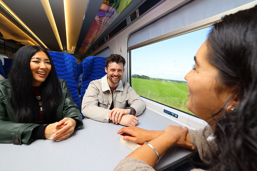 Three passengers sitting on a table seat