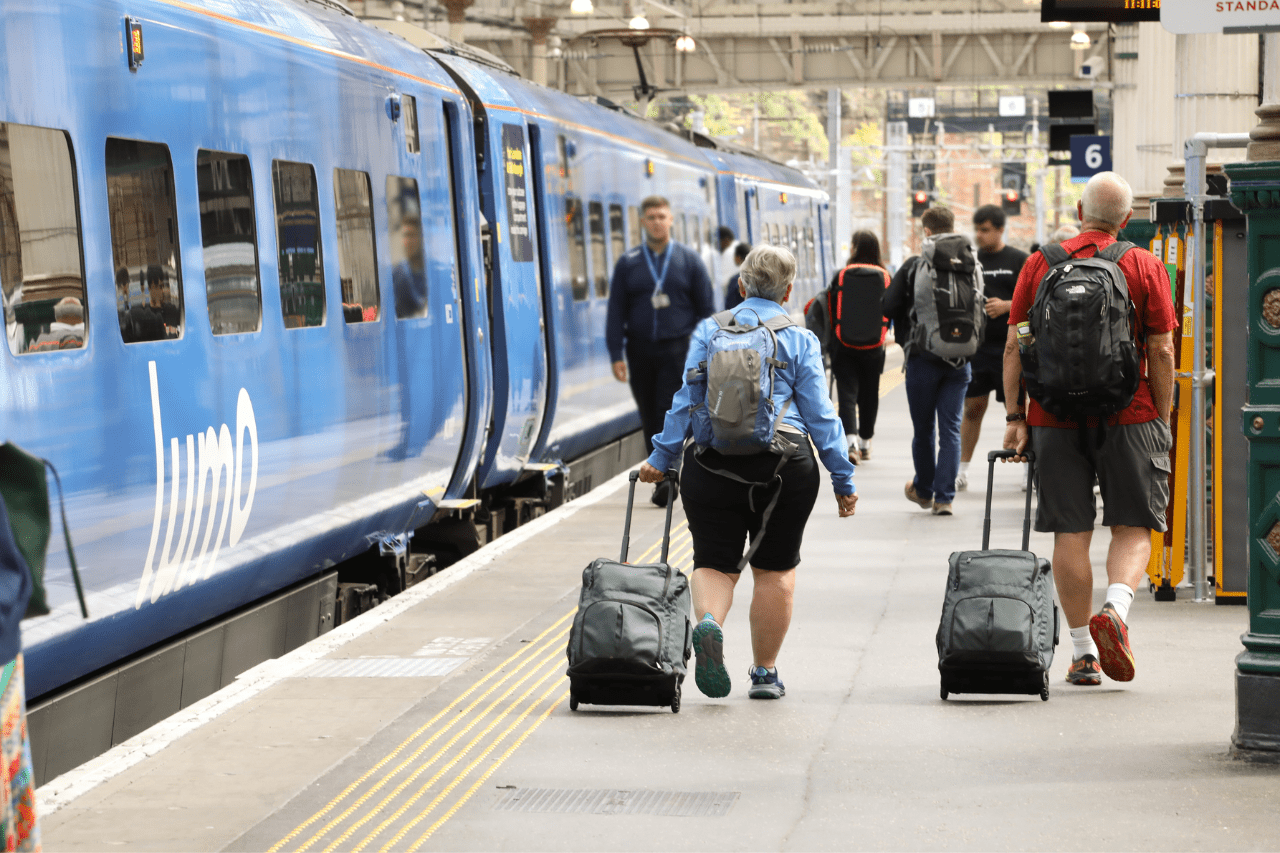 lumo passengers with luggage in train station