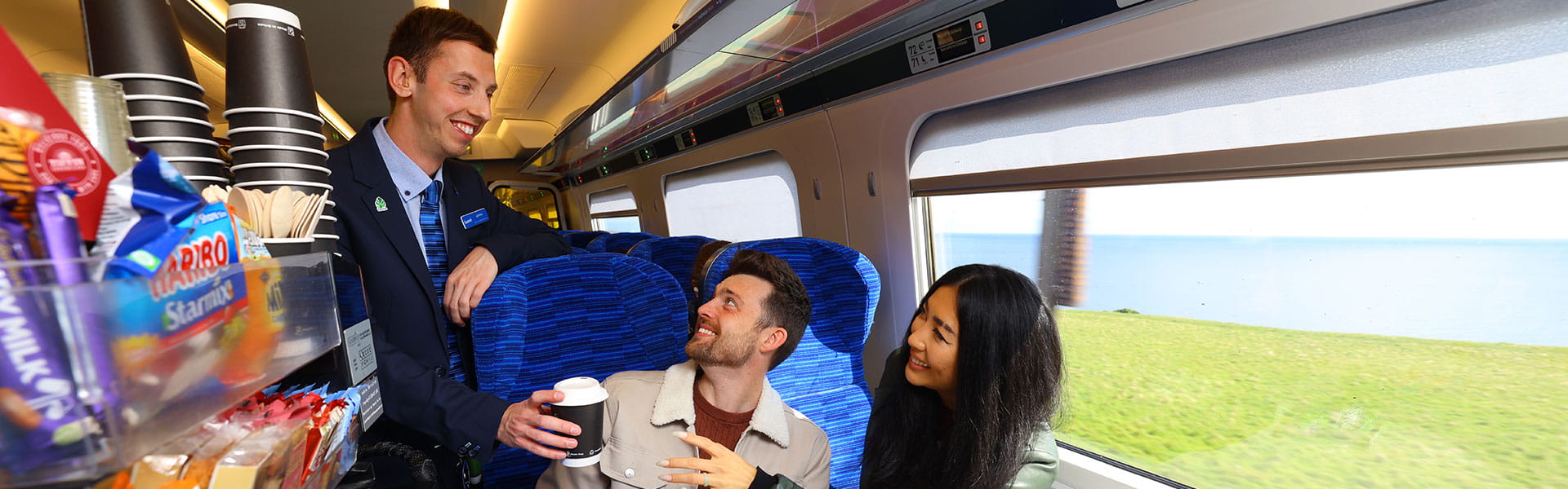 Lumo staff serving customers with catering trolley