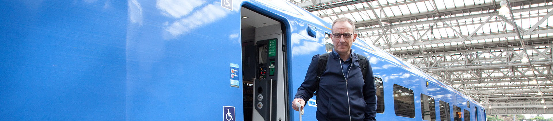 elderly passenger leaving lumo train