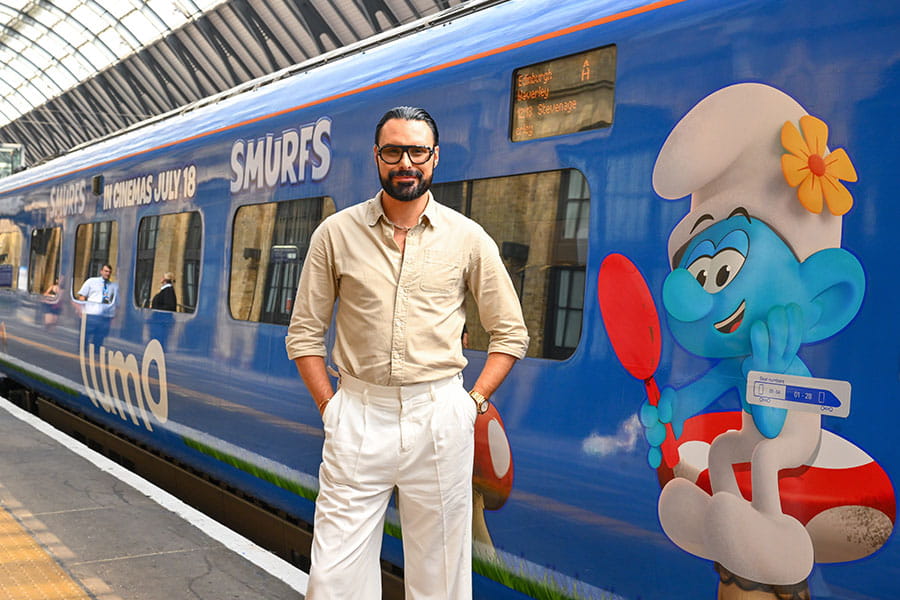 Rylan standing next to Lumo train
