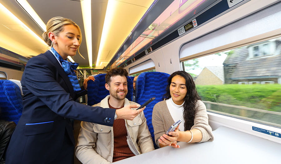Lumo staff scanning tickets to customers on the train