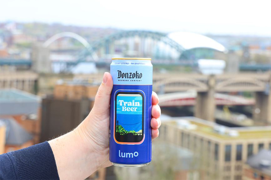 hand holding a train beer can in front of the Quayside in Newcastle