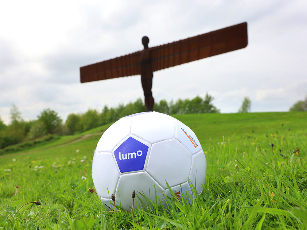 Image of a Lumo football ball in front of the Angel of the North