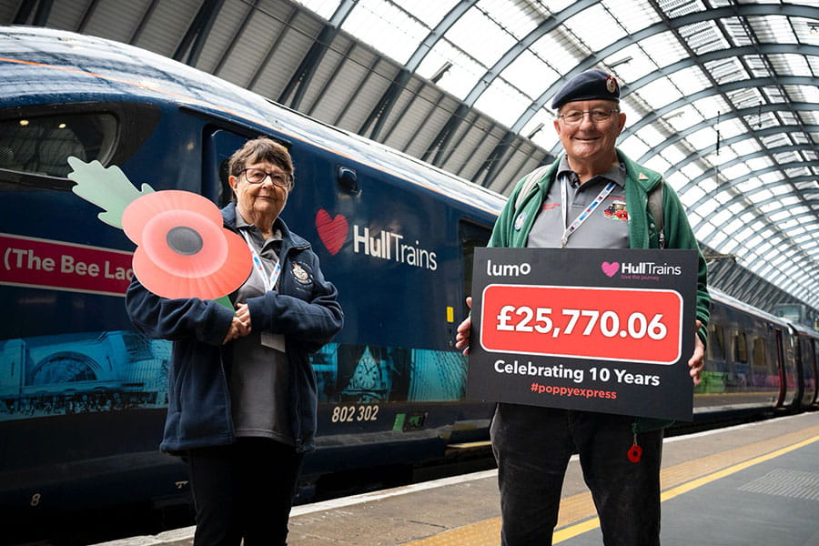 Poppy seller Denis Scaife and his wife Barbara in front of Hull Trains train