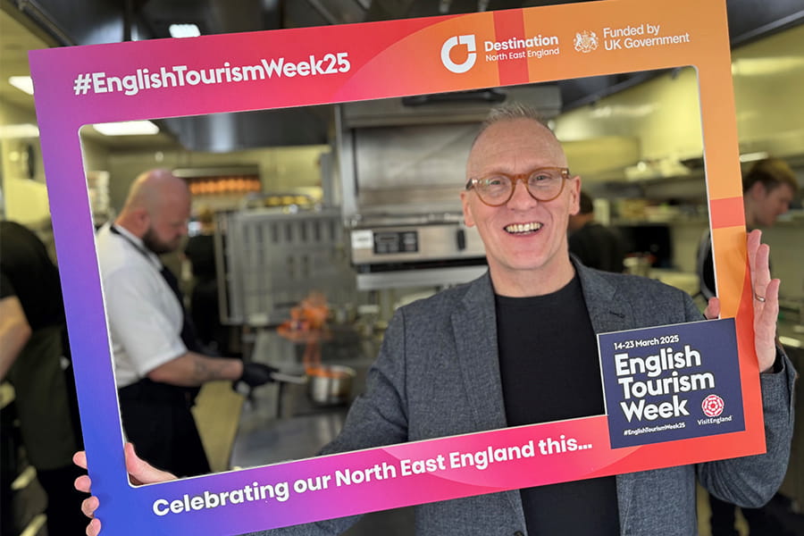 Alfie Joey, broadcast and event host, holding an English Tourism Week sign