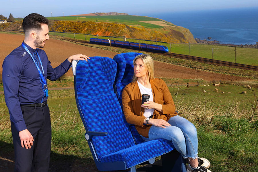 Lumo ambassador next to a customer sitting in new seats