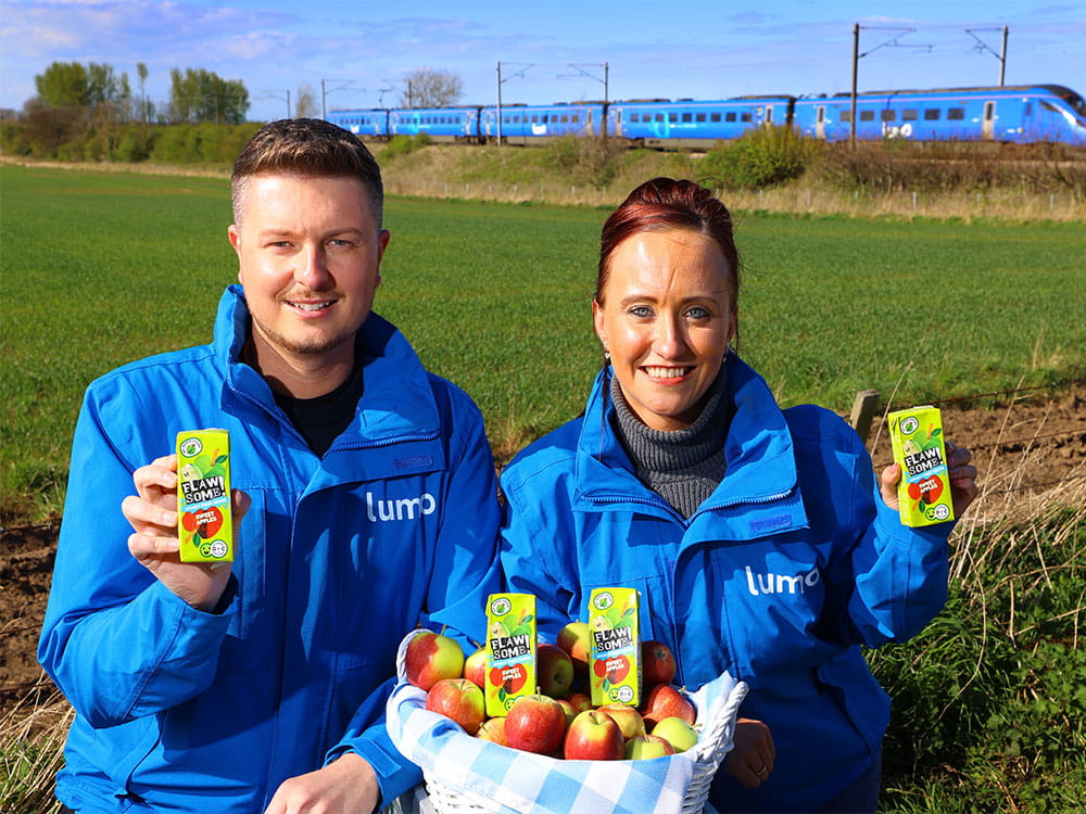 lumo staff holding flawsome apple juice carton