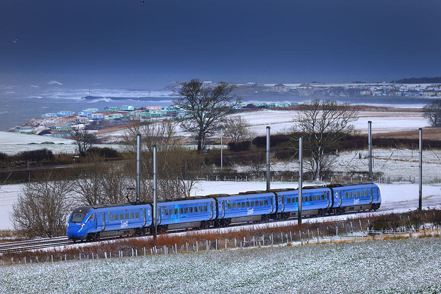 Lumo train passing through a field of snow