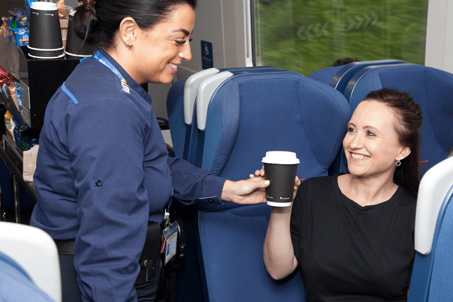 Lumo Customer Ambassador offering coffee to a customer