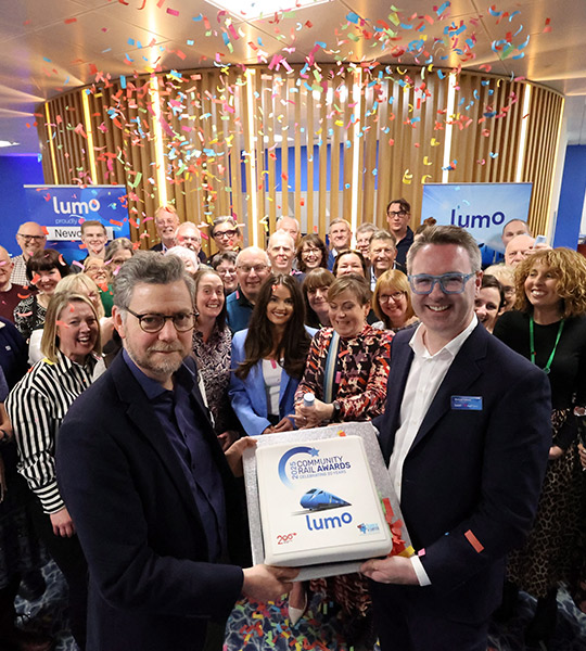 Lumo and Community Rail Awards representatives in a reception