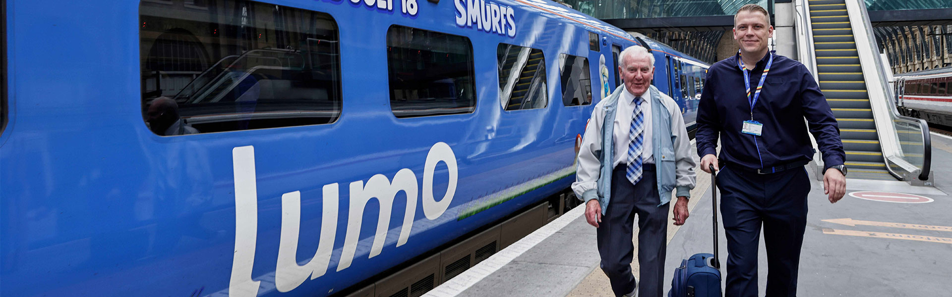 Charlie Barker and Lumo member of staff next to a Lumo train