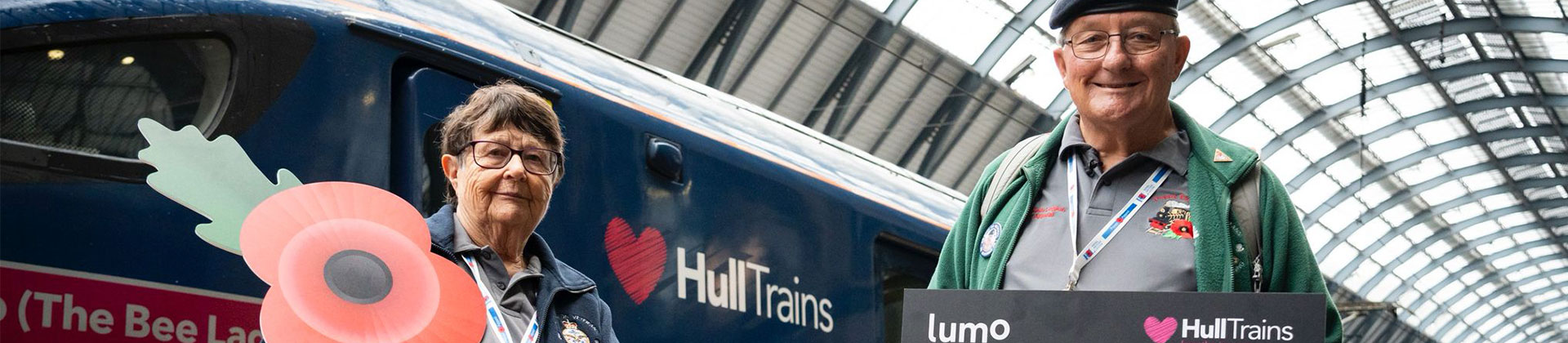 Poppy seller Denis Scaife and his wife Barbara in front of Hull Trains train