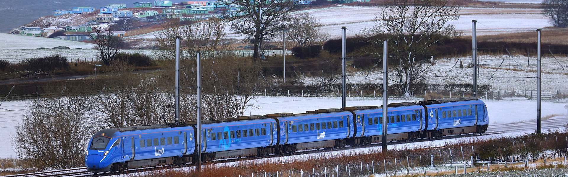 Lumo train passing through a field of snow