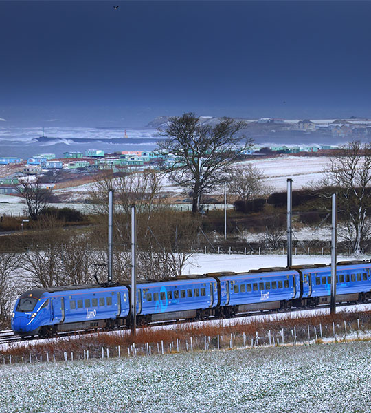 Lumo train passing through a field of snow