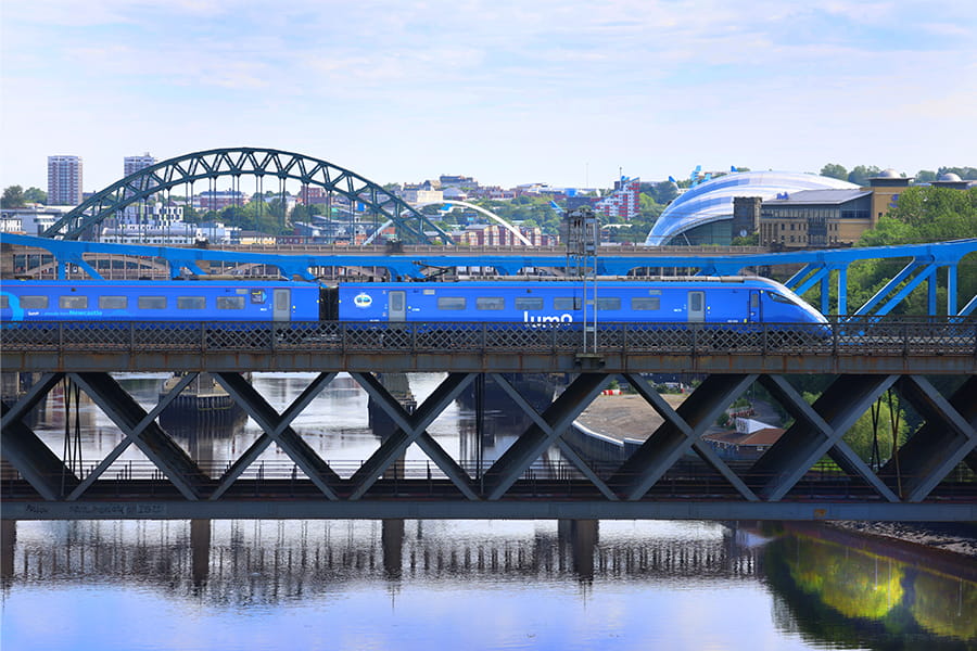 Lumo train crossing Tyne Bridge in Newcastle
