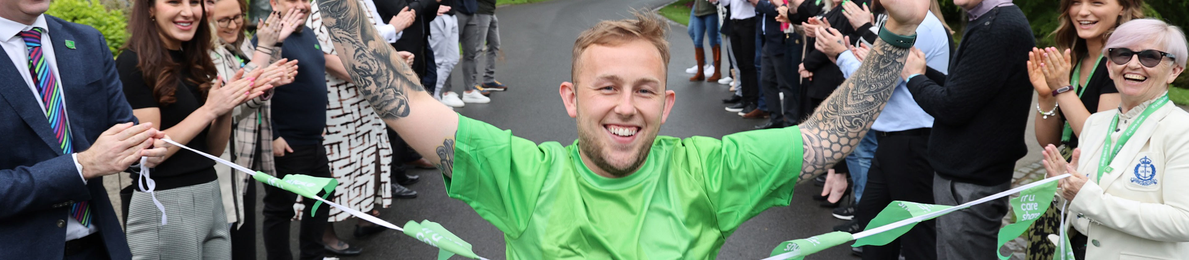 image of founder Matthew Smith reaching the finish line in a charity race