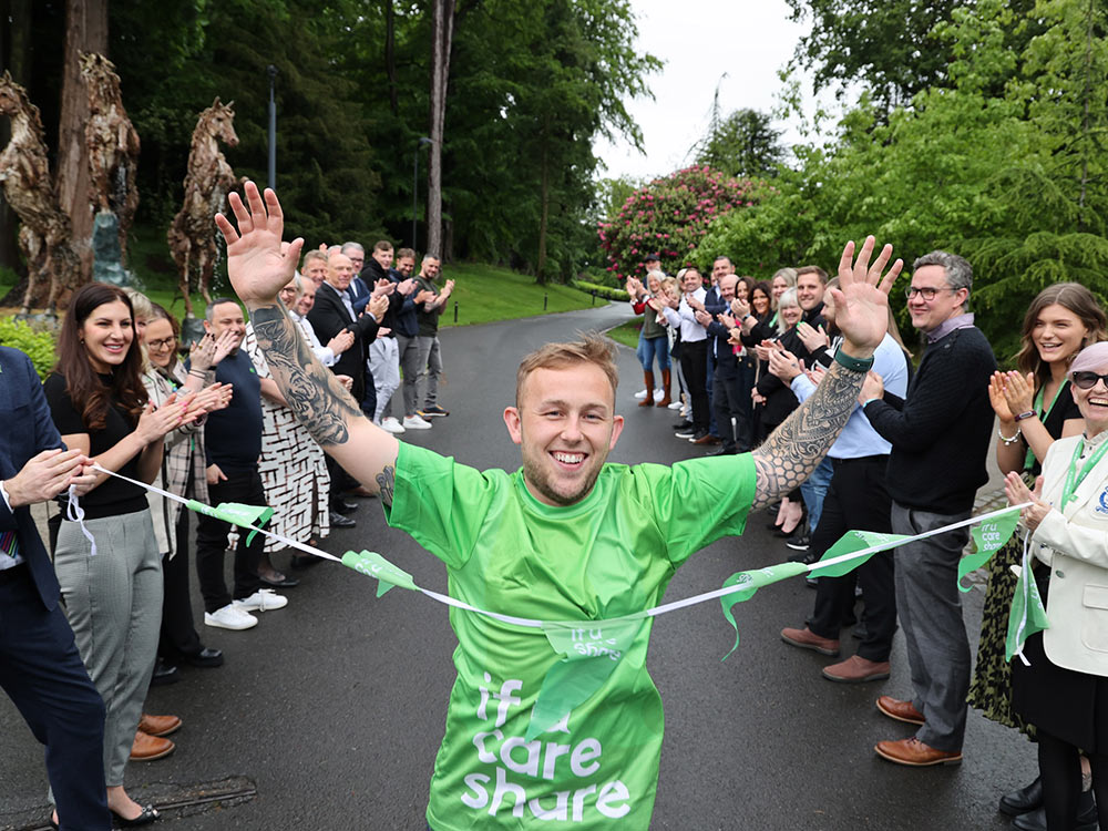 image of founder Matthew Smith reaching the finish line in a charity race
