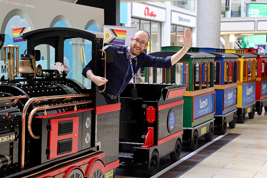 Lumo driver greeting from a Lumo branded mini express train at Metrocentre