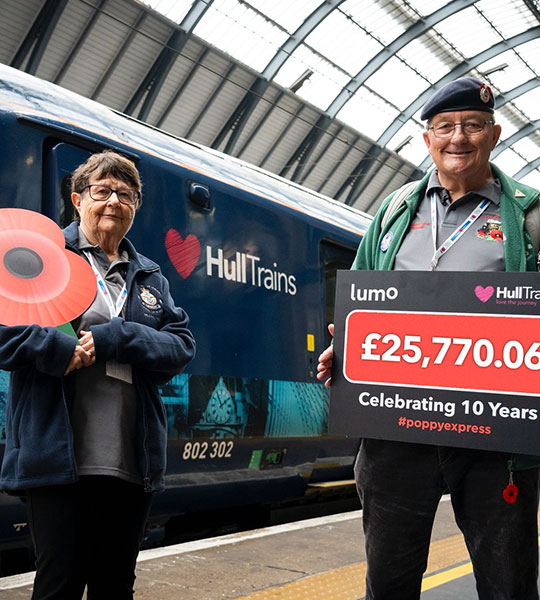 Poppy seller Denis Scaife and his wife Barbara in front of Hull Trains train