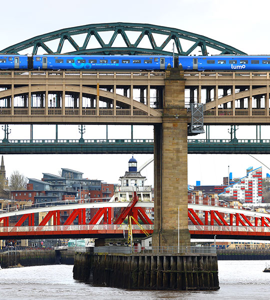 Lumo train going through Tyne bridge