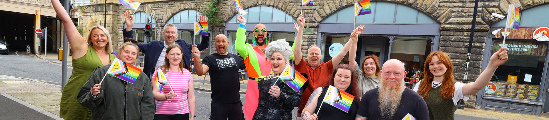 group of people holding pride flag