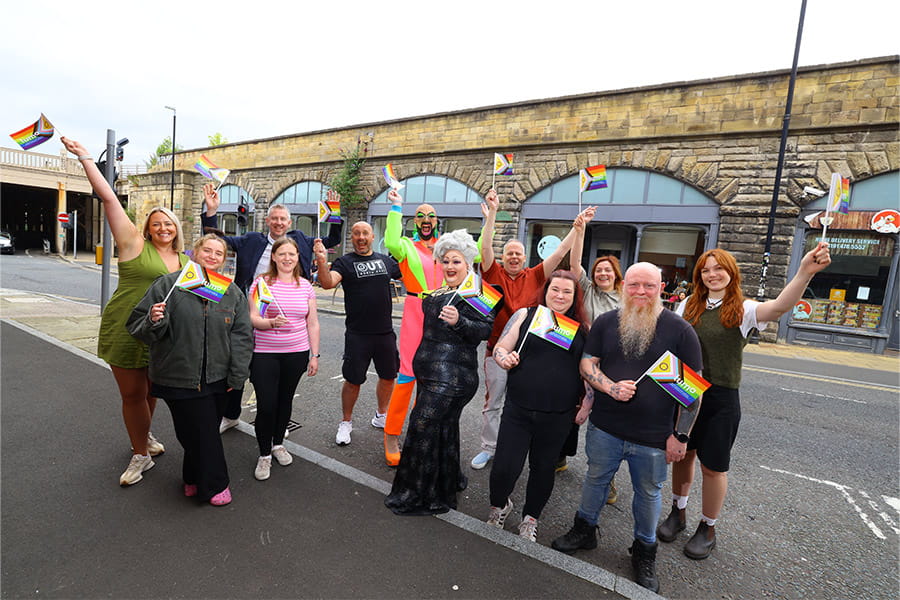 group of people holding pride flag
