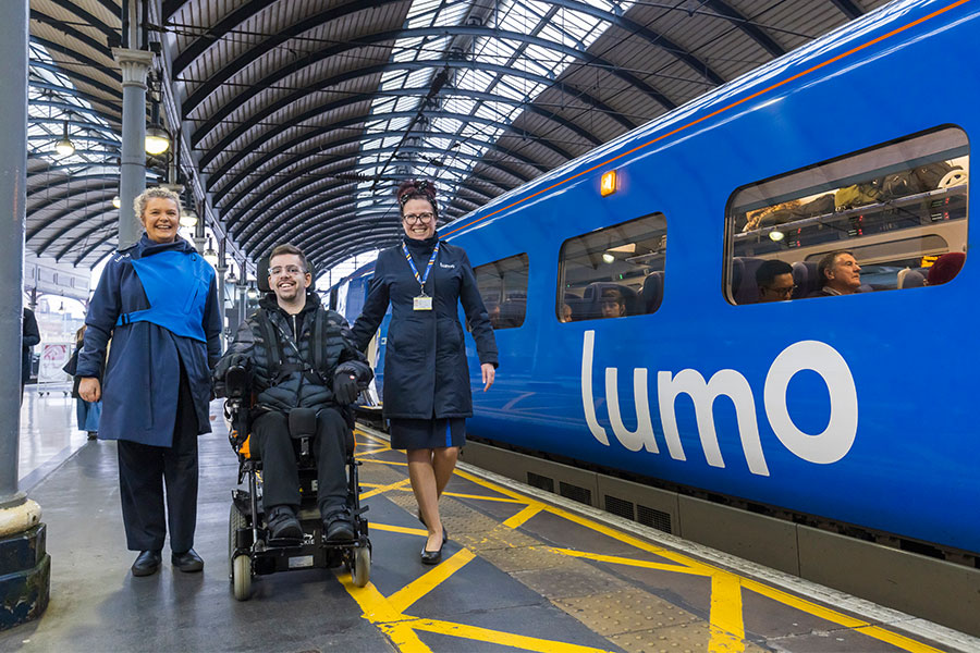 Two Lumo ambassadors assisting a customer with disabilities