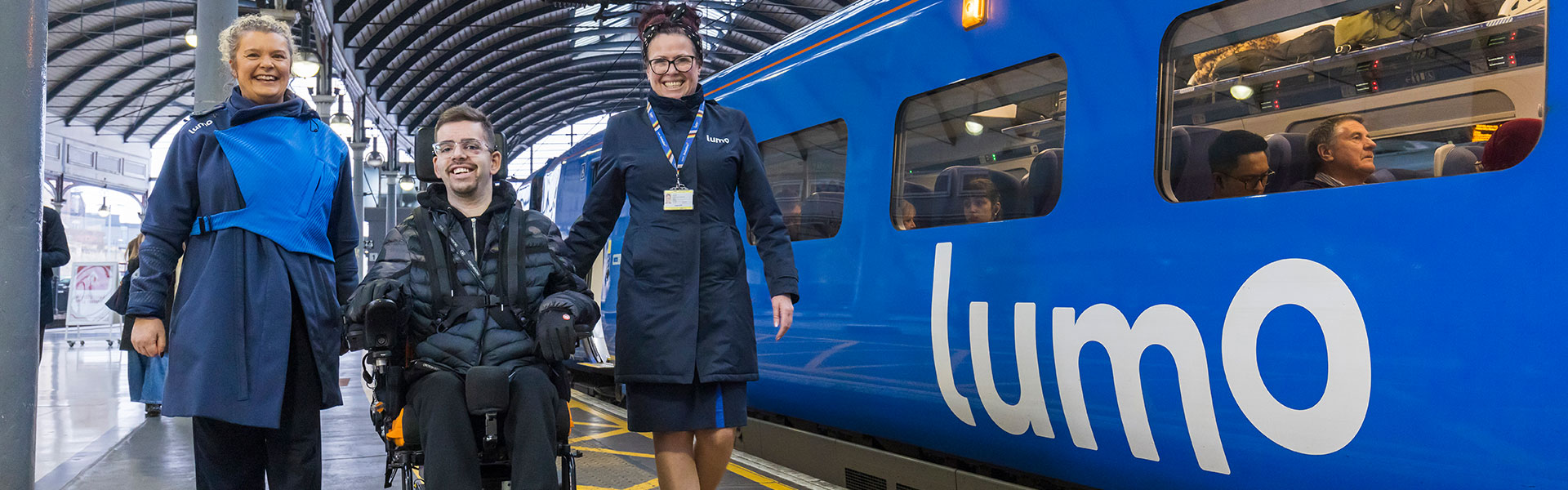 Two Lumo ambassadors assisting a customer with disabilities