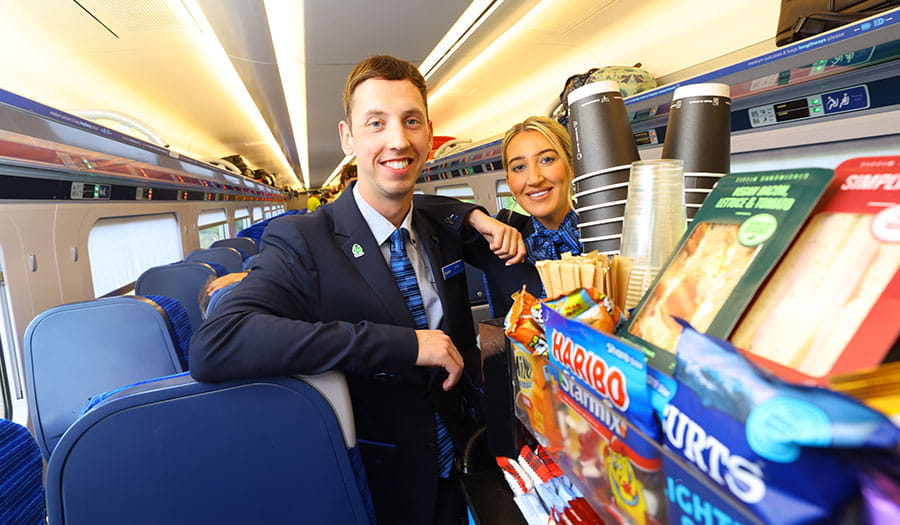 Two members of Lumo staff with the catering trolley