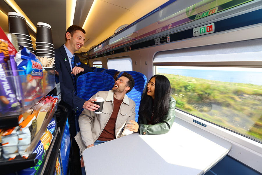 Lumo staff serving coffee to passengers